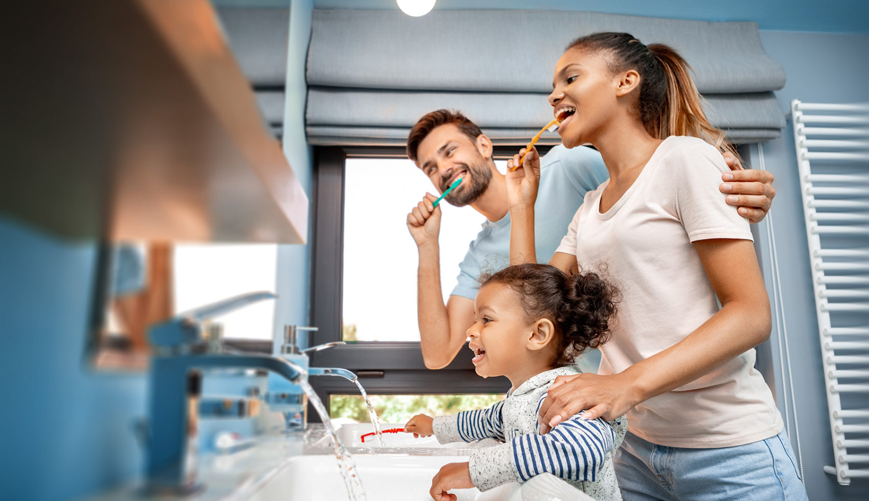 Family Brushing Teeth in Mirror